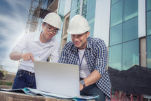View Of Workers And Architects Who See Details About Construction On A Computer.