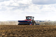 Red tractor driving on a field