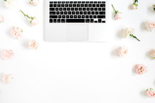 Laptop And Flowers Pattern Made Of Beige Rose Buds On White Background. Flat Lay, Top View. Floral Background.