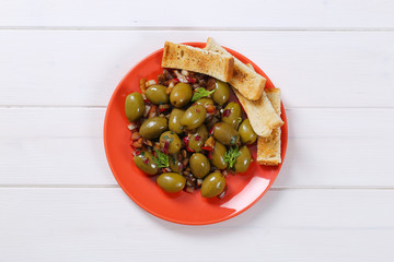 Wall Mural - marinated green olives with toast