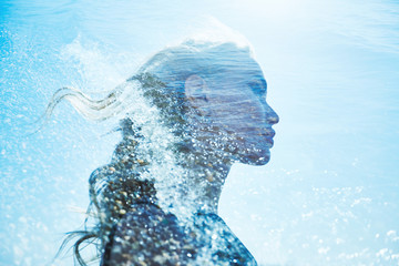 Summer portrait of a girl in blue sea waves. Beautiful blonde on the background of the sea, summer vacation at sea. A mysterious girl in sea foam