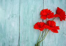 Red Poppy Flowers On Wooden Surface