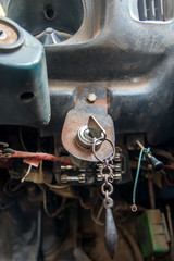 Interior of old car with the ignition key and dashboard