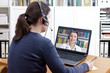 © agenturfotografin - Woman with headset in front of her computer making a video call with her doctor, e-health, telehealth or telemedicine concept.