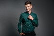 © Drobot Dean - Happy young man posing isolated over grey background