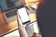 © oatawa - Close up of women's hands holding smart phone with blank copy space white screen for create content.