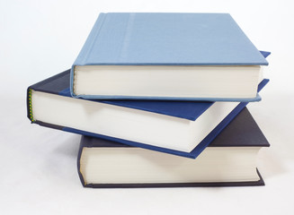 Three dark colored books on white background.