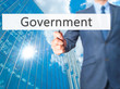 Government - Business man showing sign