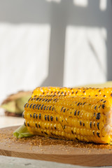 Poster - two grilled corn on a wooden plate