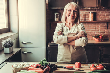 Wall Mural - Old woman in kitchen