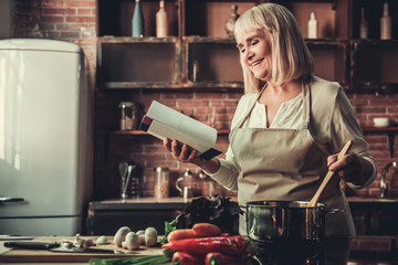 Wall Mural - Old woman in kitchen