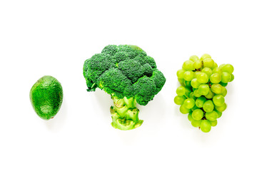 green fresh broccoli, grape and avocado for fitness diet food on white table background top view