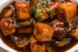 Spicy Paneer or chilli paneer or cottage cheese, served in white Dish with capsicum and onion, favourite indian starter menu, selective focus