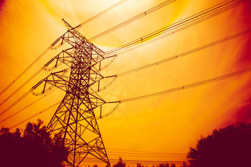 high voltage electric post in red sunset sky