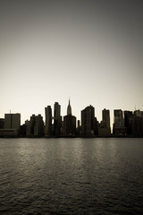 Wall Mural - Empire State Building and buildings under the shade in Manhattan with East river in old vintage style