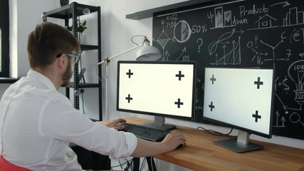 Multitask Business Connections Green Screen. Man Working with two computers, and a tablet, all with green screen. 20s 4k