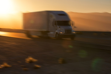 American style truck on freeway pulling load. Transportation theme