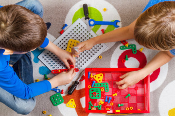 Wall Mural - Kids playing with toys tool kit.Top view