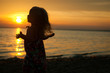 © Iryna - A Little girl by the sea at sunset