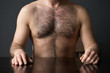 hairy chest of man sitting at table