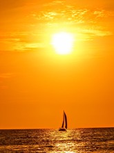 Sailboat Silhouette In Deep Orange And Yellow Sunset Puerto Vallarta Mexico