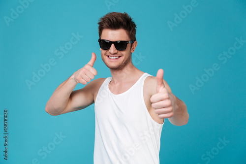Man in sunglasses showing thumbs up gesture - Buy this stock photo and ...