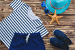 Flat still of child wear. Kid`s wardrobe. Beach and vacation clothes for a little boy.Wooden background