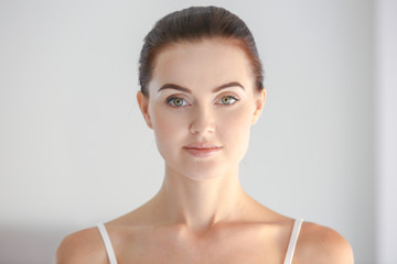 portrait of beautiful girl on light background