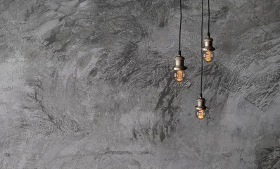 industrial pendant lamps against a rough concrete wall. the interior of the loft style. edison light