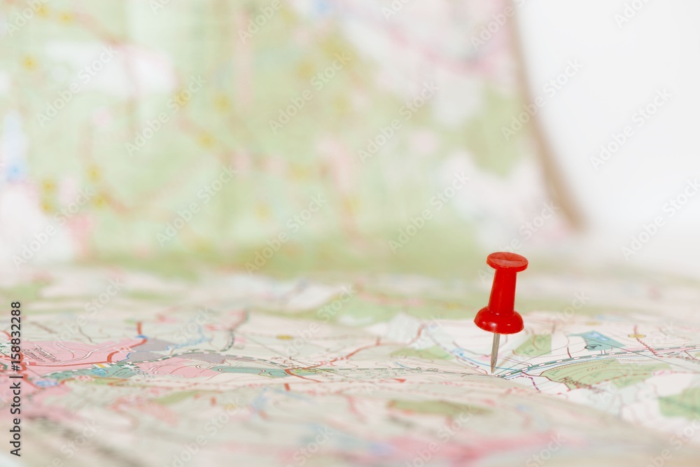 Single red pushpin marking a location on an open map Stock Photo ...