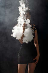 Canvas Print - Beautiful girl vaping from e-cigarette.