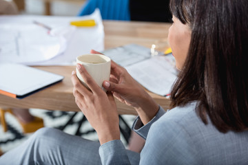 Wall Mural - Cropped shot of young african american businesswoman holding cup and drinking coffee