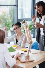 Wall Mural - Professional young businesswomen working together in modern office and discussing