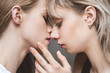 close up portrait of sensual lesbian couple kissing with eyes closed