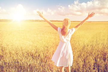 happy young woman in white dress on cereal field