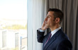 © Syda Productions - businessman calling on smartphone at hotel room