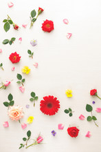 Colorful Flowers  Background  Made Of Pink And Red Roses, Green Leaves, Gerbera And Pansy Flowers On White Background. Flat Lay, Top View