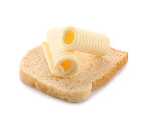 Wall Mural - Slice of bread with butter curls on white background