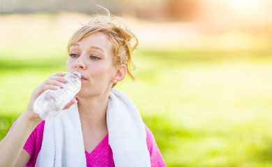  Young Fit Adult Woman Outdoors with Towel Drinking From Her Water Bottle.