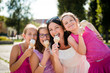 Mother with three daughters eating ice cream. Fun day outdoor.