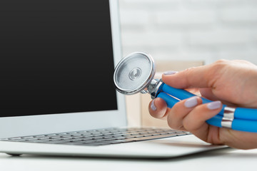 Hands of medical doctor woman with laptop.