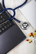 Laptop, stethoscope, tablet and pills