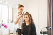 © satura_ - beauty and people concept - happy young woman with hairdresser at hair salon.