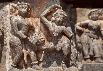 Canvas Print - Ruined dancing people on relief of the 12th century Hoysaleshwara temple in Halebidu, India.