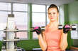 © satura_ - Sporty young woman with dumbbells in gym