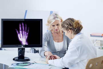 Doctor examining patient's hand