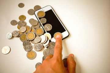 hand men touch smart phone and money on white background, Press the phone is equal to the money concept