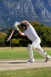 Cricket player playing on field during sunny day