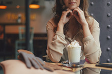 Beautiful Woman Sitting At A Coffee Shop