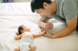 © Maa Hoo/Stocksy - Father playing with his newborn baby boy